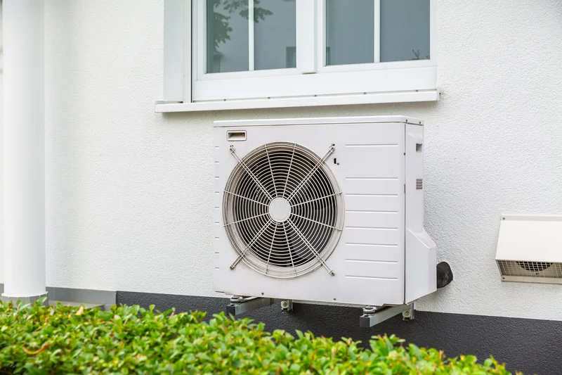 outdoor condenser unit under house window