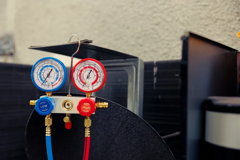refrigerant manifold gauges on hvac unit